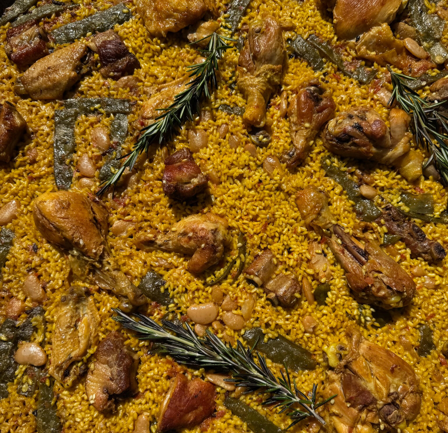 Traditional Valencian Paella – The Gourmet Paella Authentic Valencian paella with rice, chicken, rabbit, green beans, white beans and rosemary – cooked to perfection over open flames